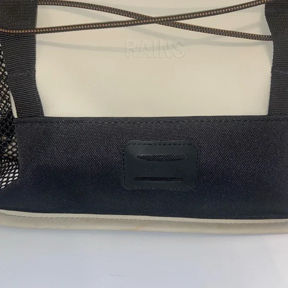 Rains Cream and Black Backpack Roll-Top Design